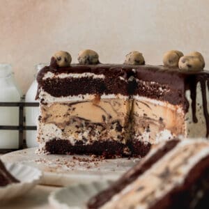 Cookie dough ice cream cake on a marble board cut into.