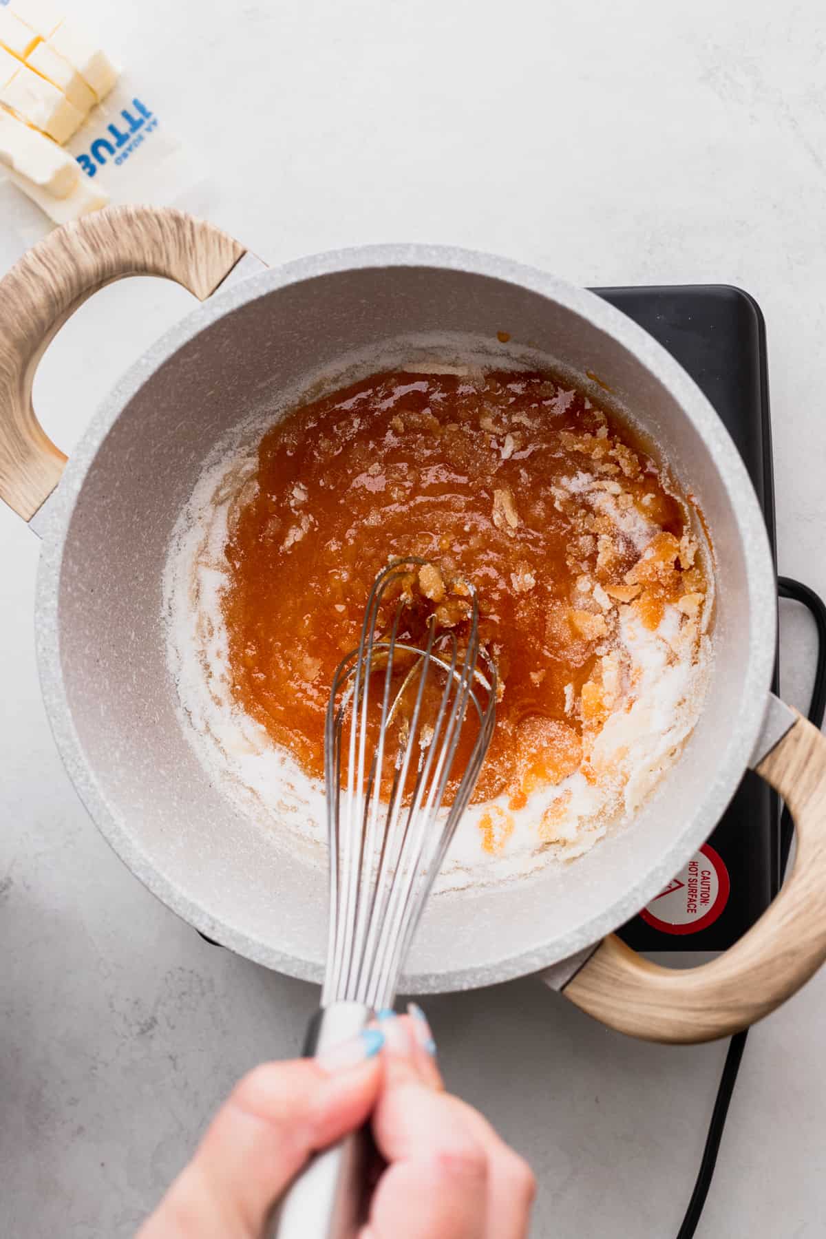 Mixing sugar in a pot.