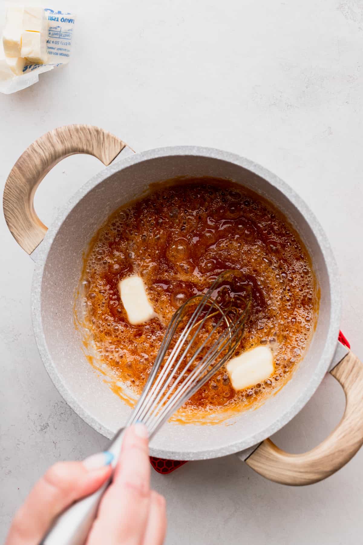 Mixing melted butter into the sugar.