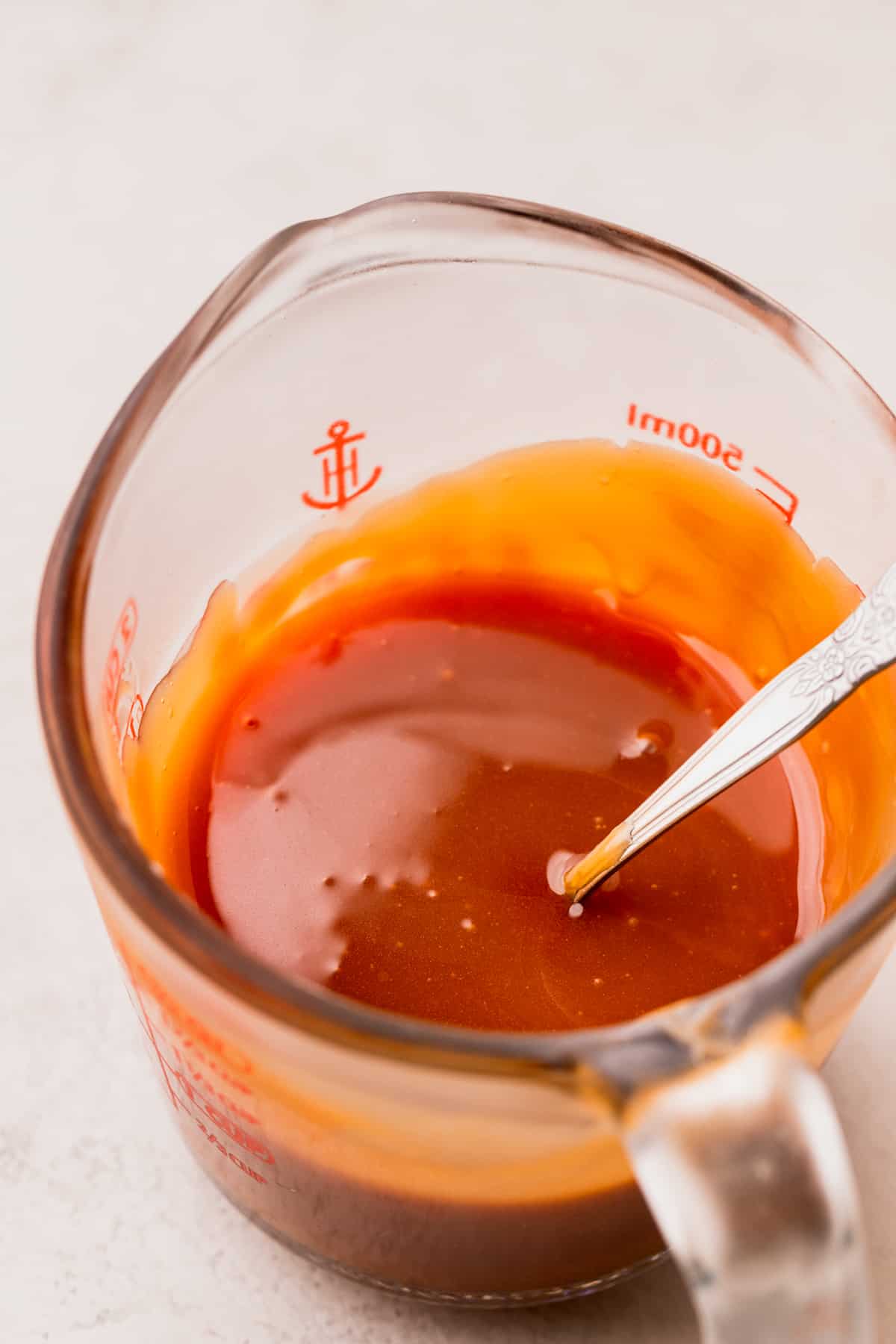 Caramel in a glass measuring cup.