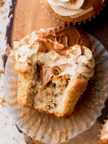 Biscoff cupcakes with a bite missing.