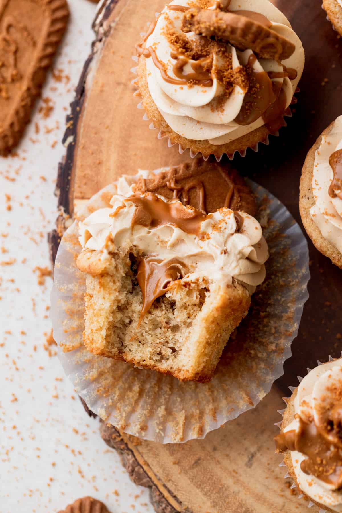 Biscoff cupcakes with a bite missing.