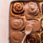 Spreading Nutella icing on top of the Nutella rolls.