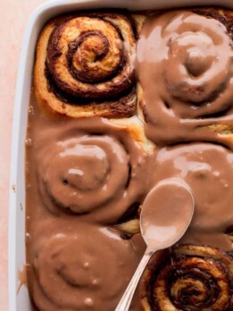 Spreading Nutella icing on top of the Nutella rolls.