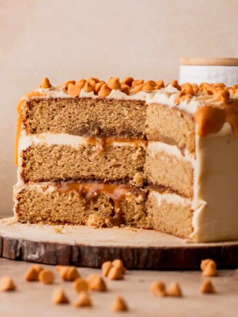 Butterscotch cake cut open on a wood board.