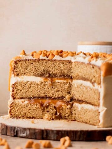 Close up of butterscotch cake on a wood board.