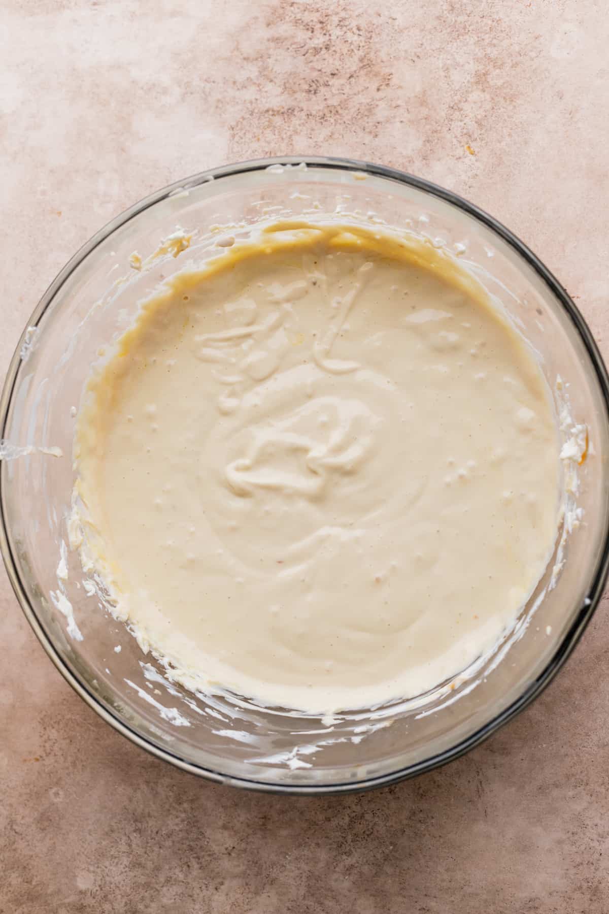 Cheesecake batter in a glass bowl.