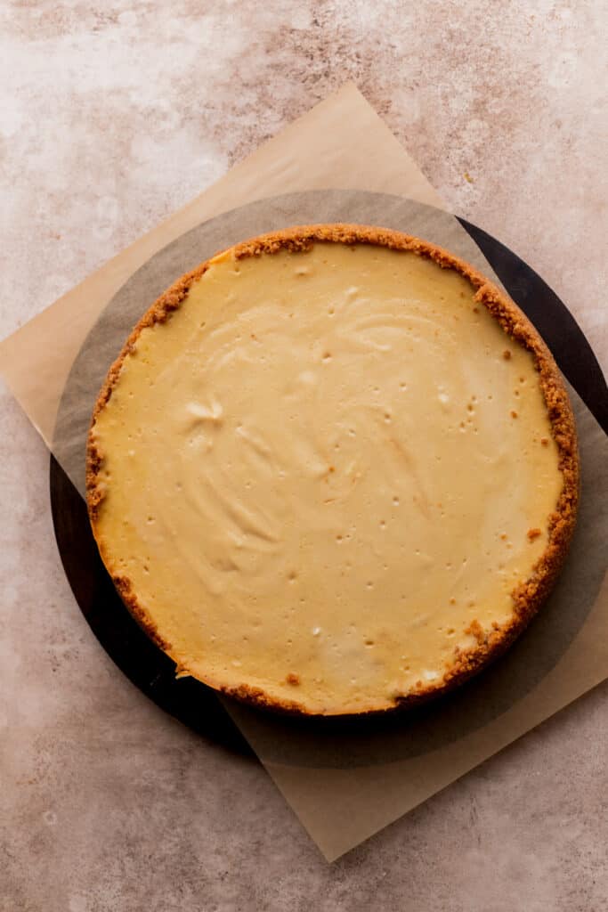 Baked cheesecake on a board.