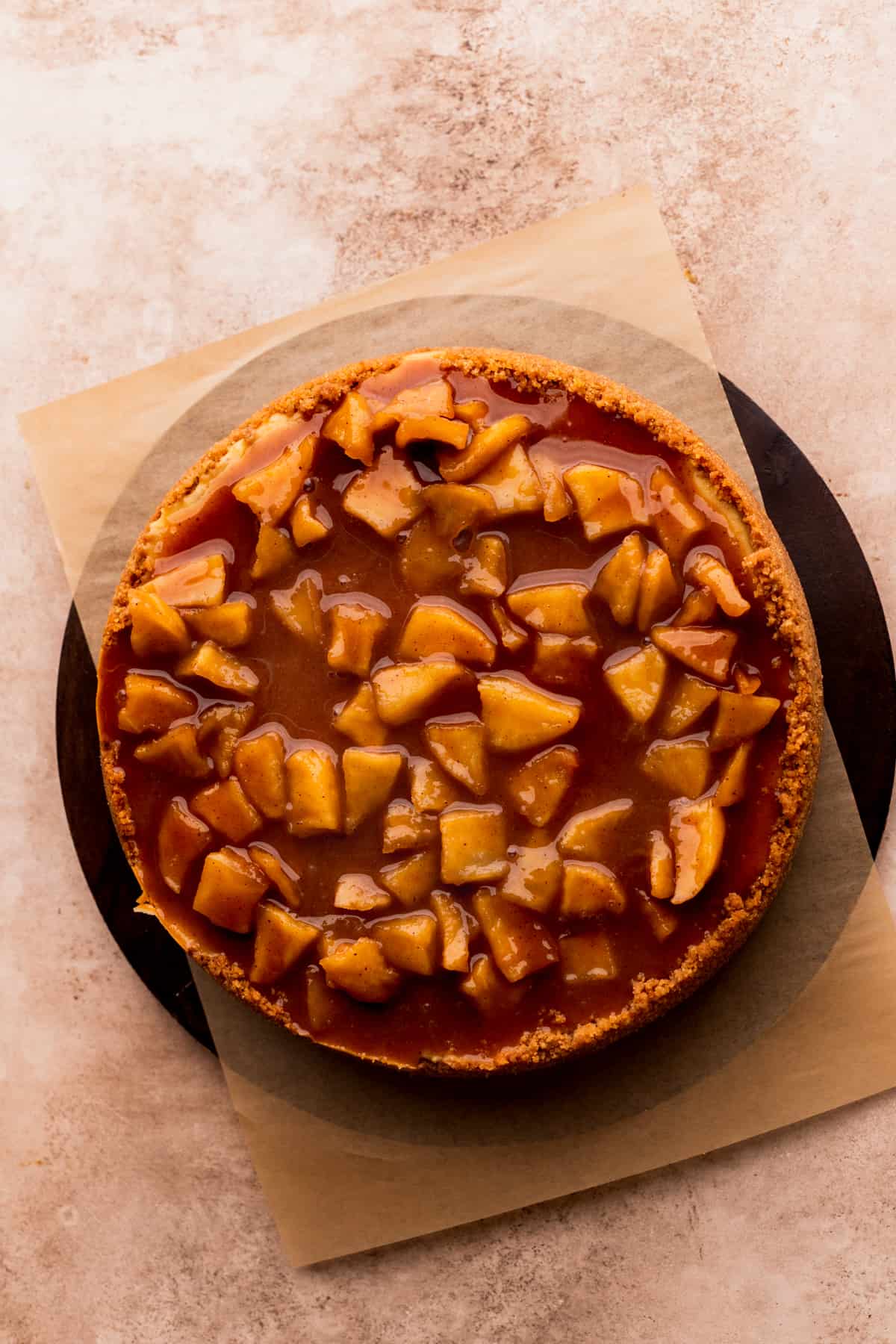 Apple pie topping on top of cheesecake.