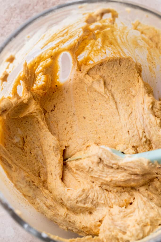 Pumpkin frosting in a glass bowl.
