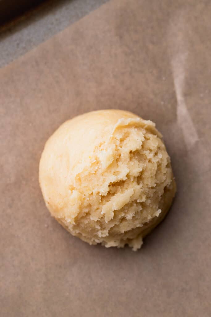Cookie dough ball on a cookie sheet.