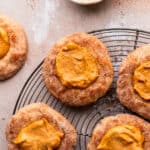 Pumpkin pie cookies on a wire rack topped with cinnamon sugar.