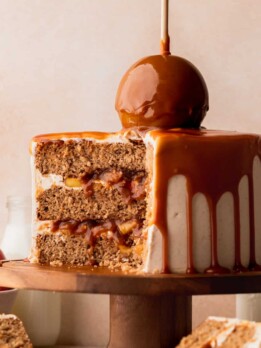 Apple cinnamon cake split open on a cake stand.