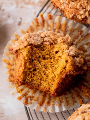 One bite missing from pumpkin banana muffins.