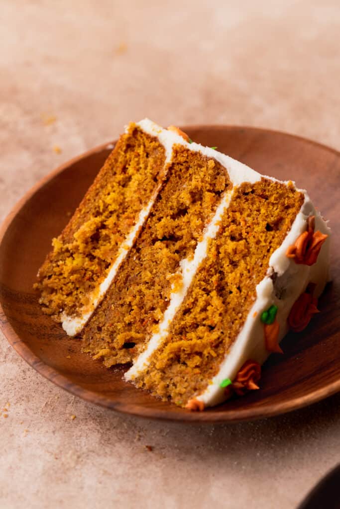 One slice of pumpkin carrot cake on a plate.