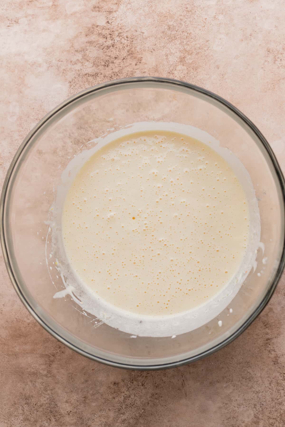 Whipped eggs in glass bowl.