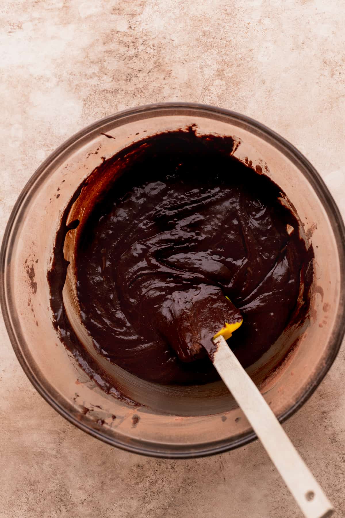 Brownie batter in a glass bowl.