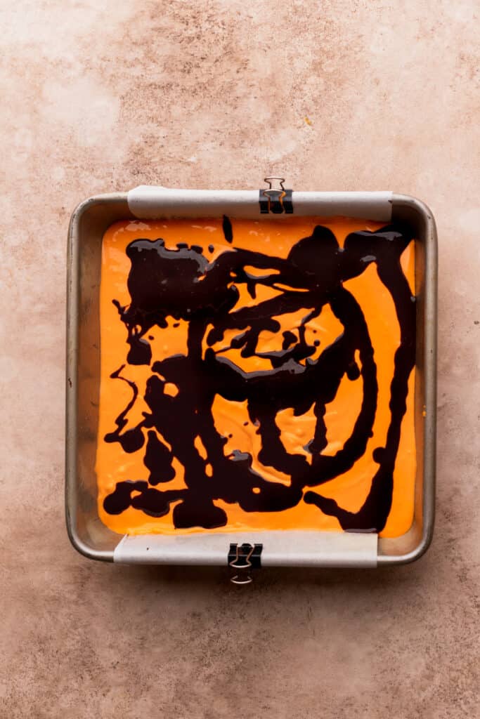 Drizzled brownie batter on top of cheesecake layer.