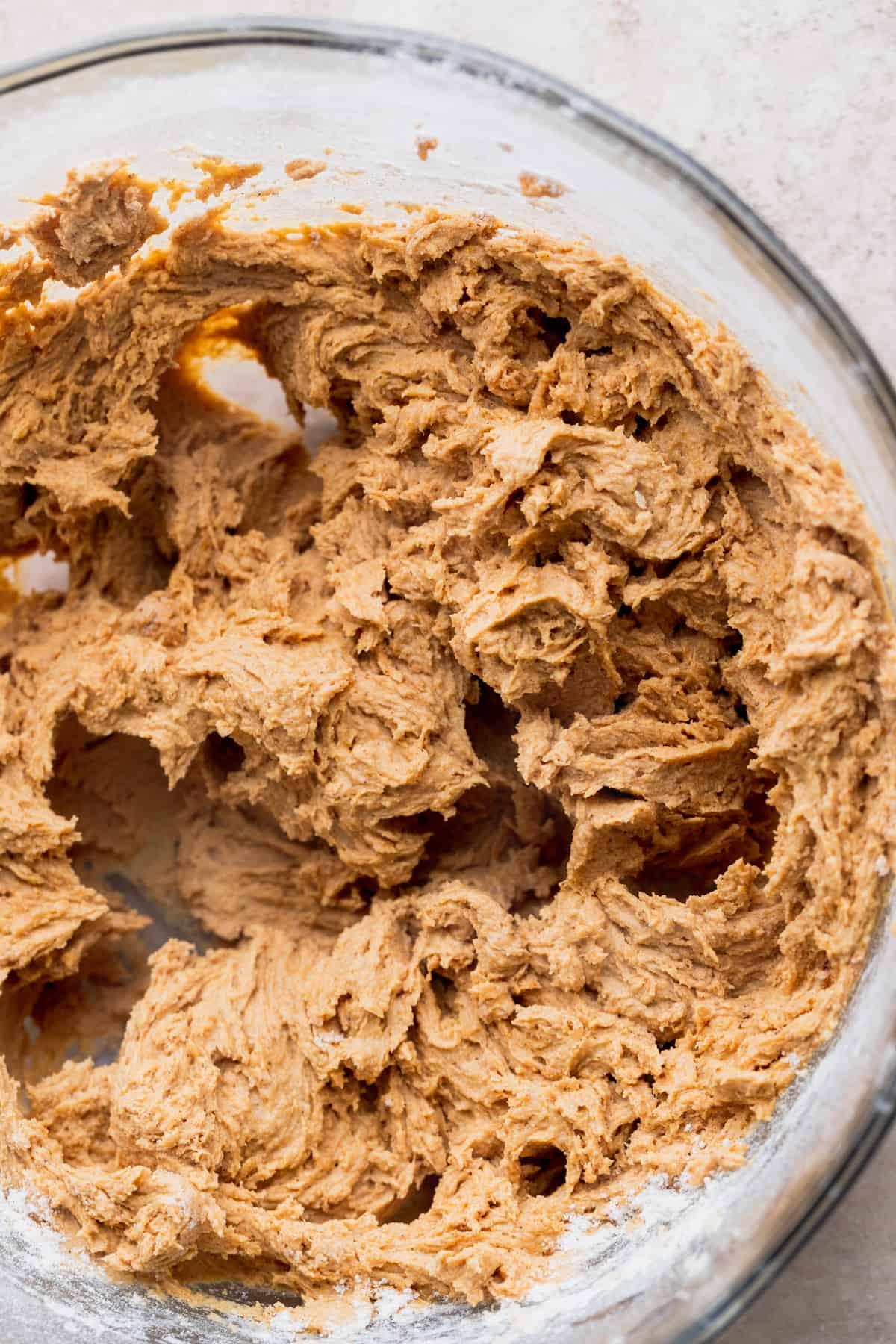 Pumpkin cookie dough in a glass bowl.