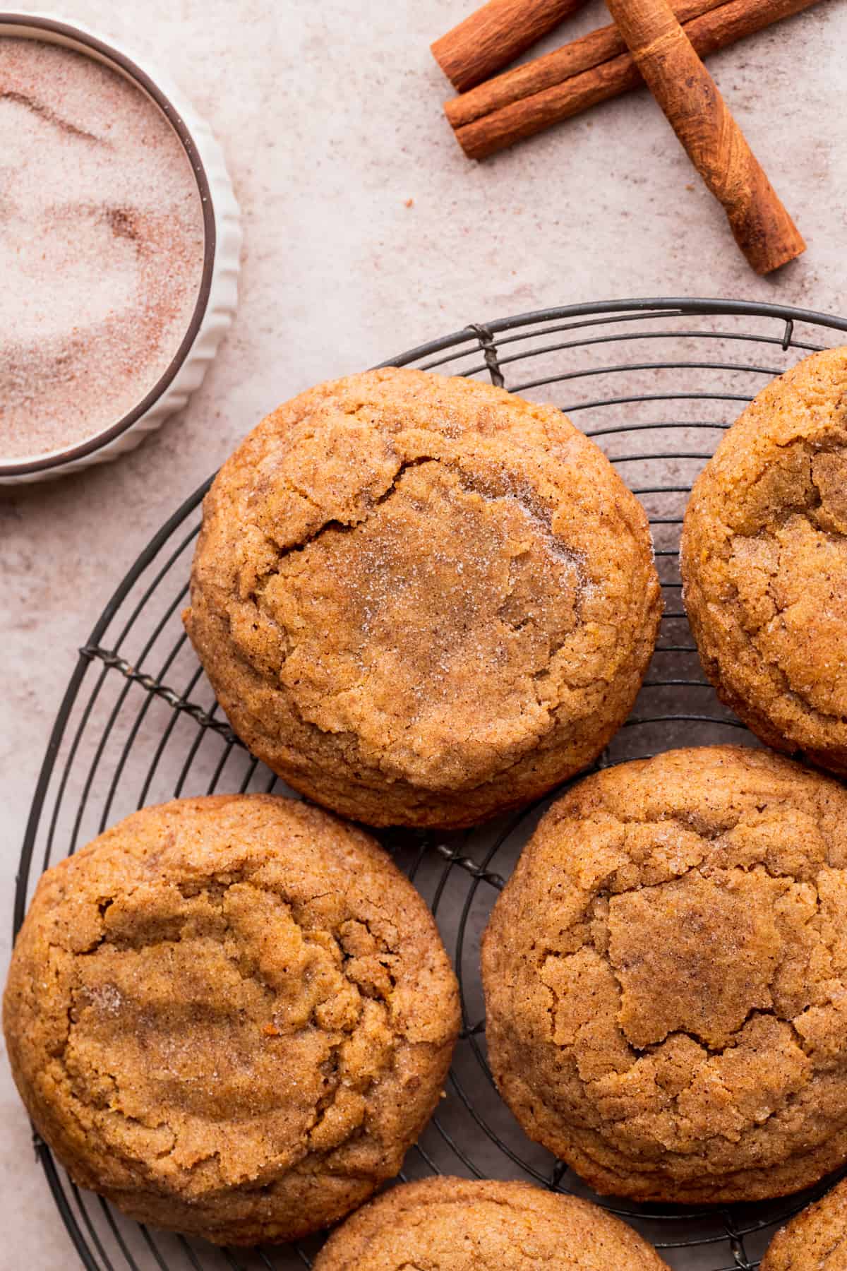 Chewy pumpkin snickerdoodle cookies on a wire rack.