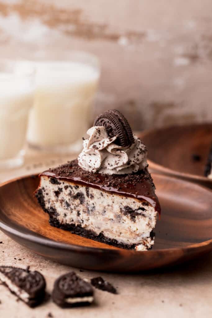 One slice of oreo cheesecake on a plate.