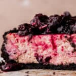Close up of cherry cheesecake cut in half.