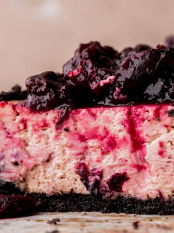 Close up of cherry cheesecake cut in half.