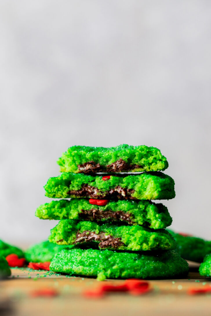 Stack of two Grinch cookies split in half.