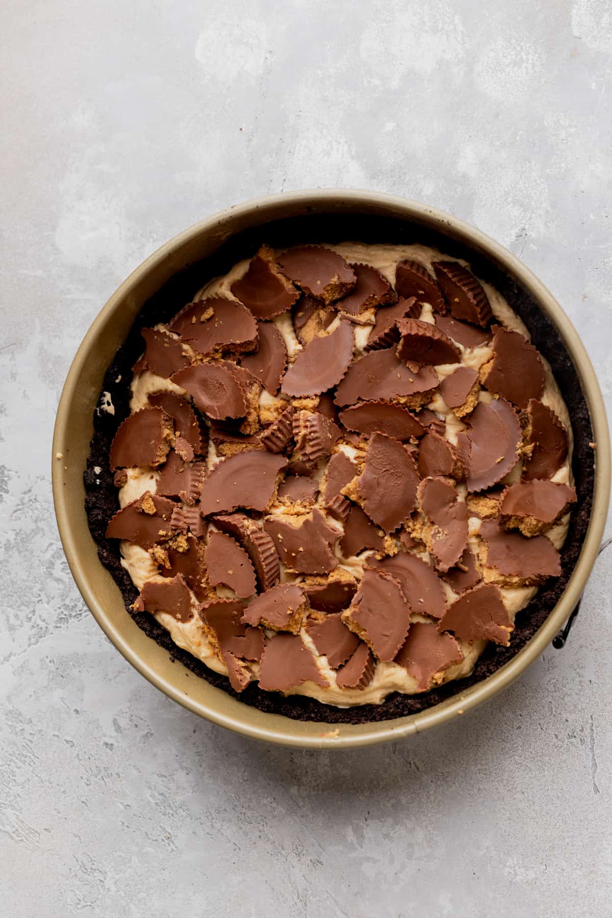 Peanut butter cups crumbled in the pie in a pan.