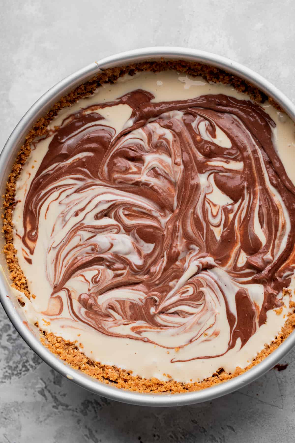 Swirled chocolate cheesecake on the cheesecake batter.