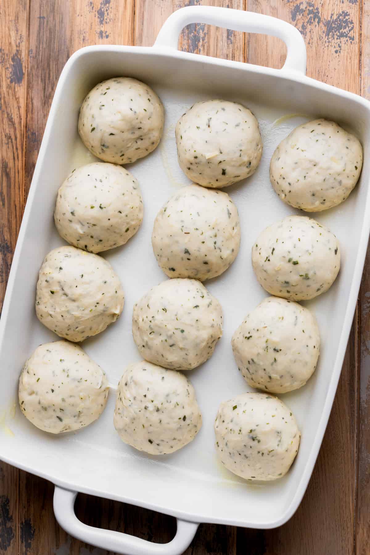 Dough balls in a pan.