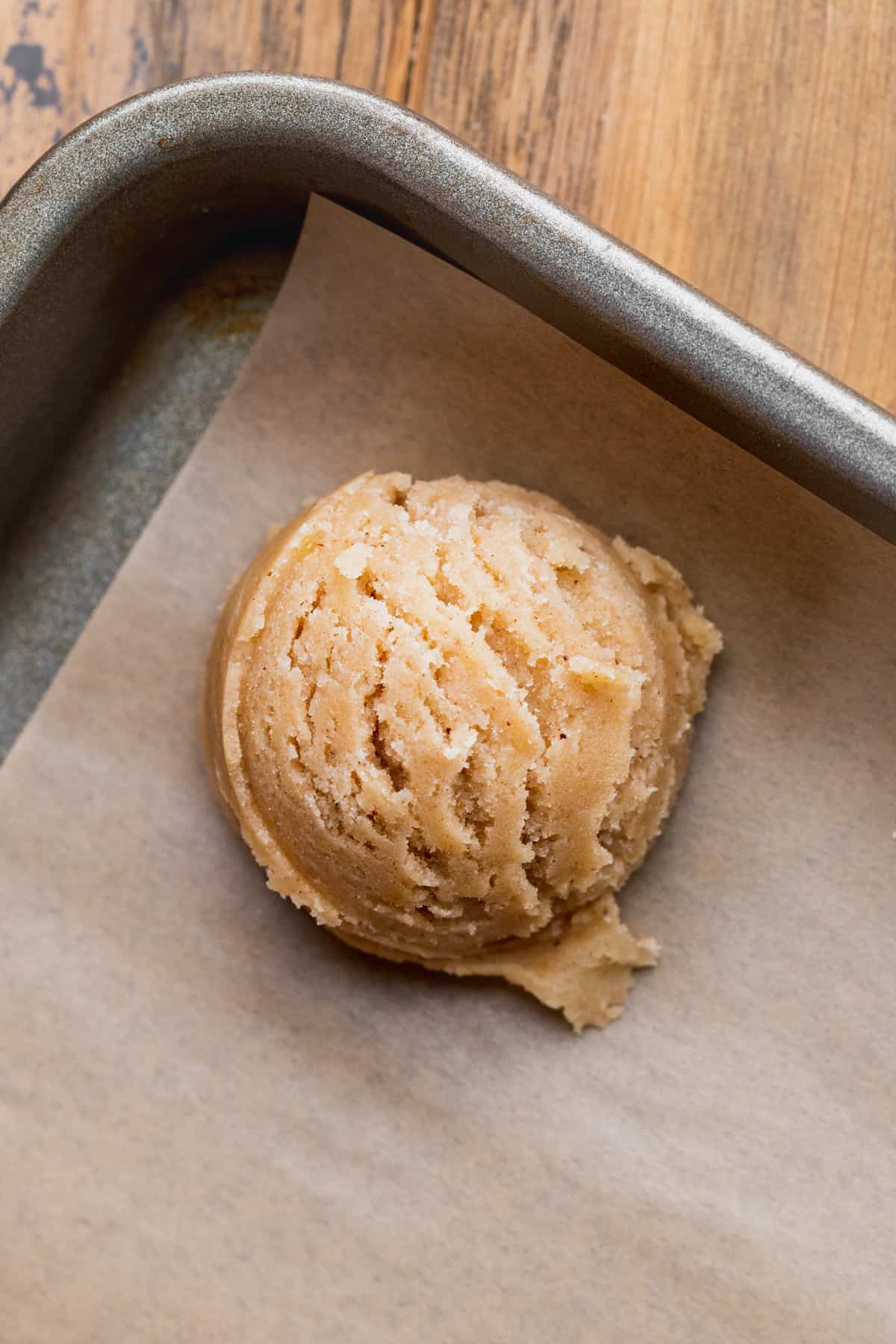 Cookie dough ball on a cookie sheet.