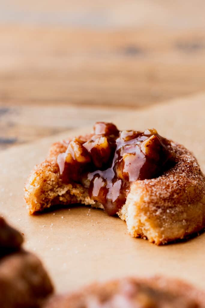 Side view of pecan pie cookie with a bite missing.