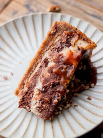 One slice of cheesecake on a plate.