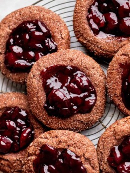 Cherry cookies on a wire rack.