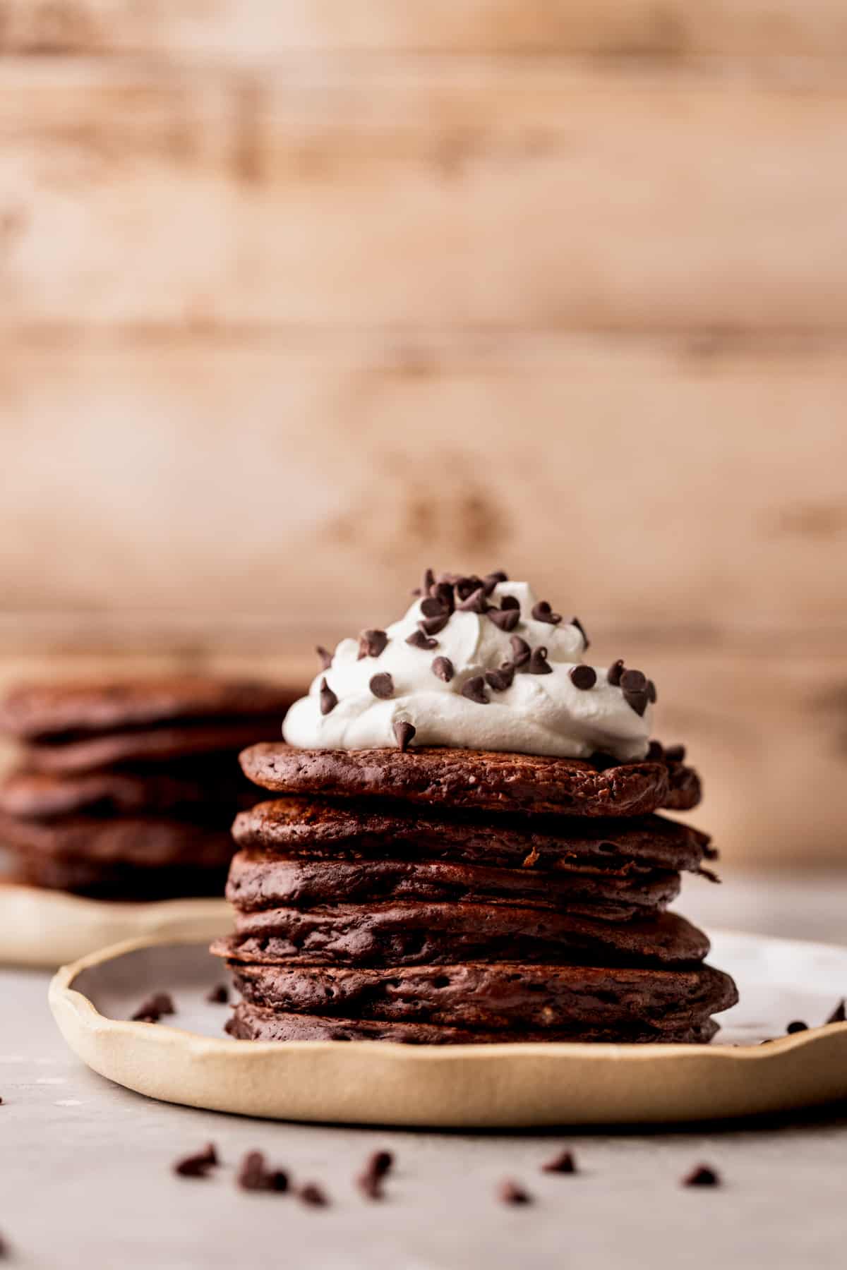 Stack of chocolate pancakes on a plate.
