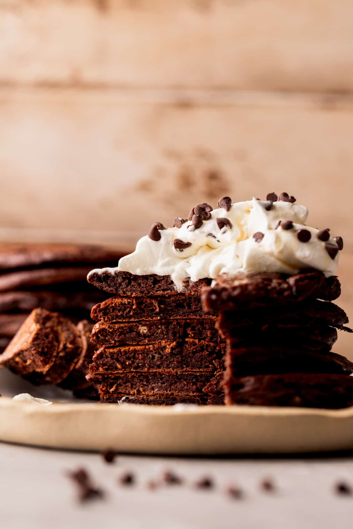 Stack of chocolate pancakes split open on a plate.