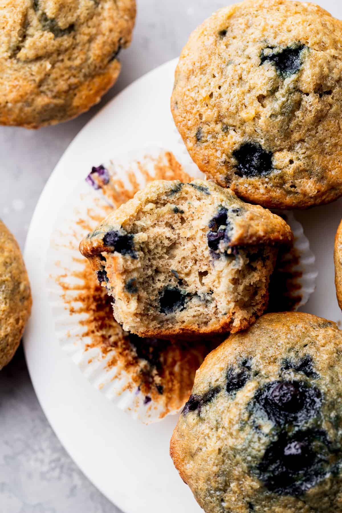 A bite missing from a banana blueberry muffin.