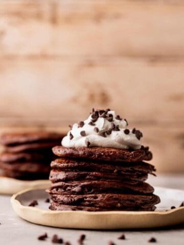 Stack of chocolate pancakes on a plate.