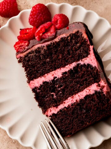Chocolate raspberry cake slice on a plate.