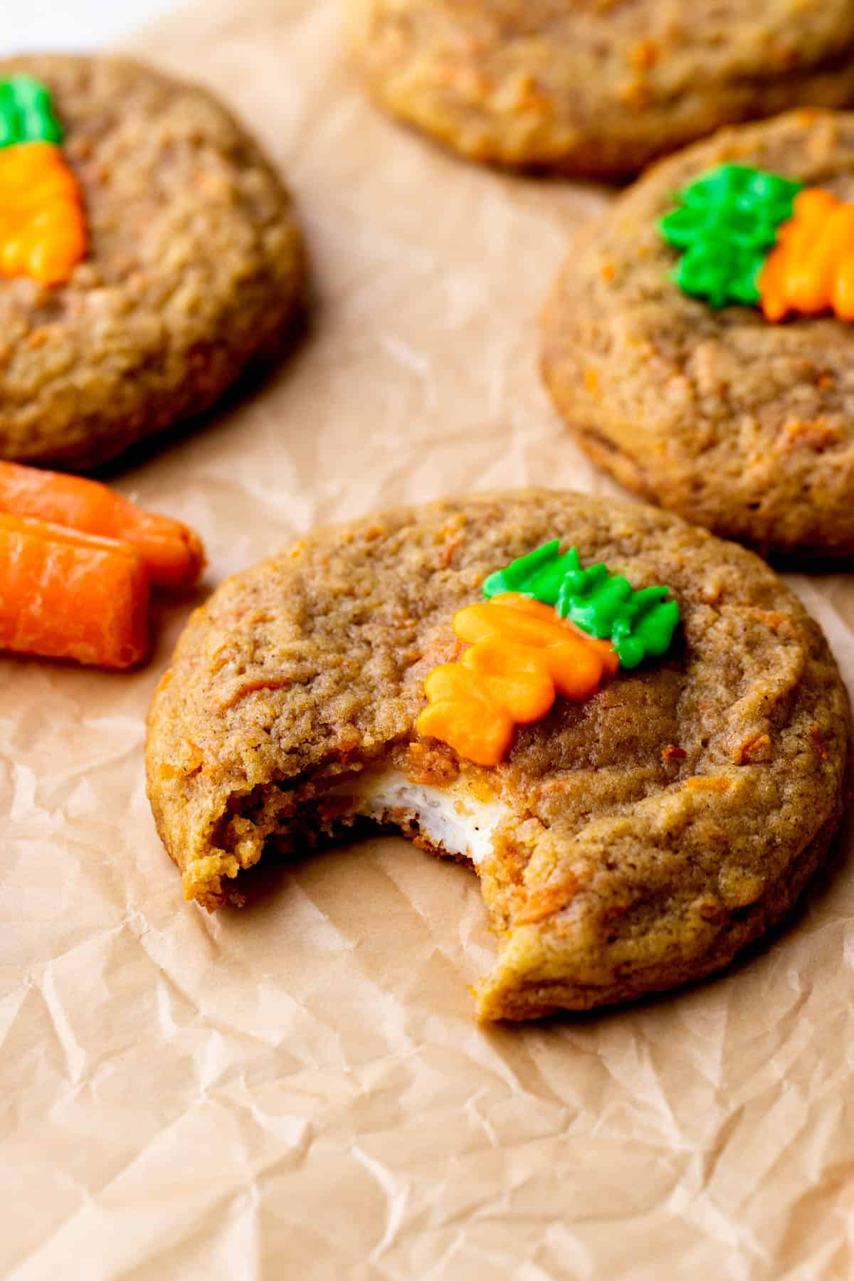 One carrot cake cookie with a bite missing.