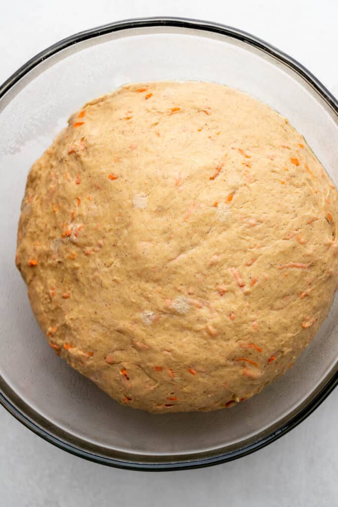 Dough that has risen in a glass bowl.
