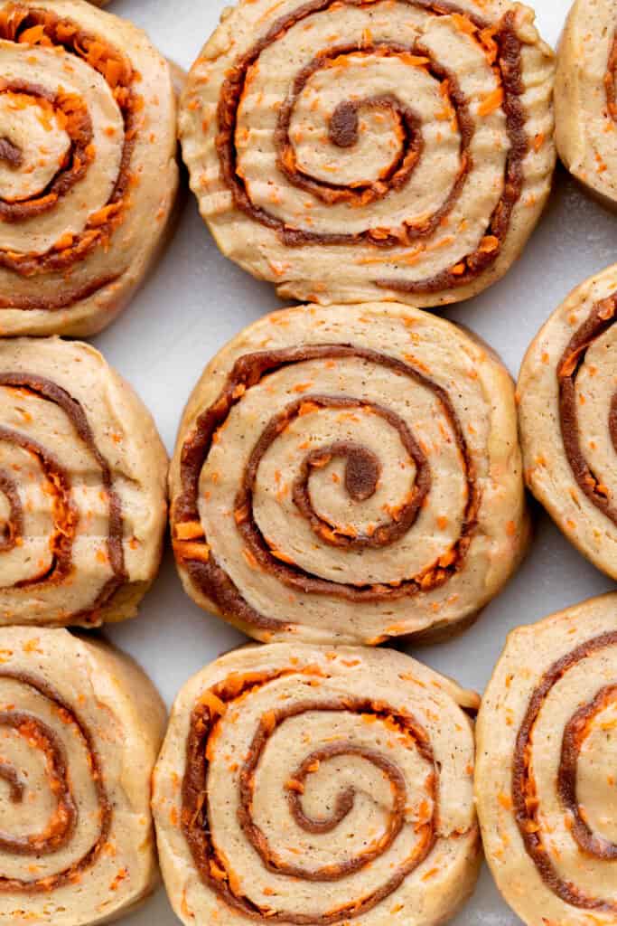 Carrot cake dough rolls in a pan.