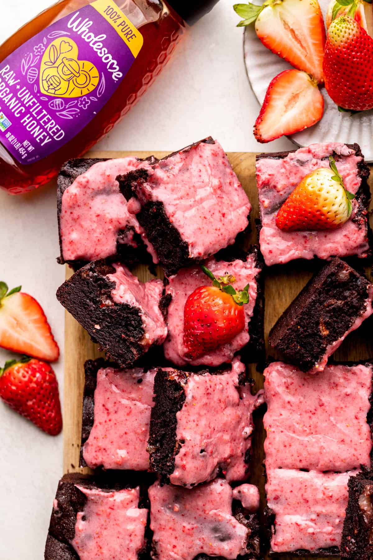 Strawberry brownies on a wood board.