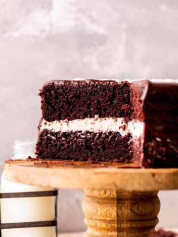 Cake cut into on a cake stand.