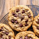 Oatmeal chocolate chip cookies in a wire rack.