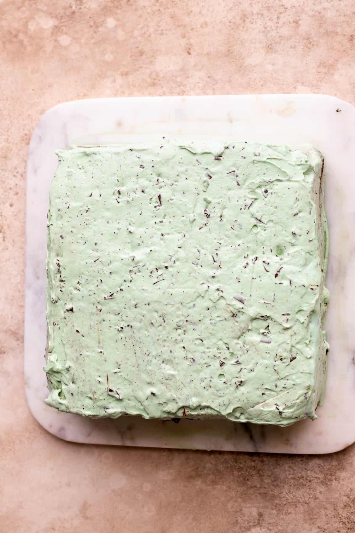 Mint whipped cream on top of ice cream.