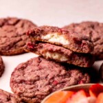 Strawberry cheesecake split open on top of another cookie.