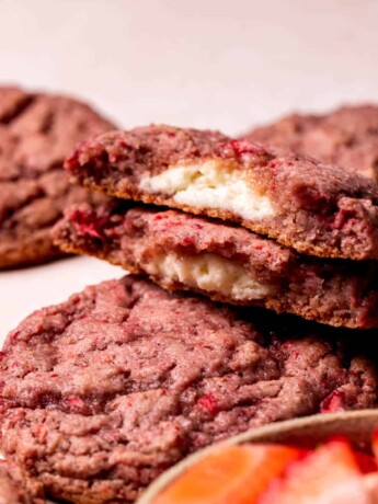 Strawberry cheesecake split open on top of another cookie.