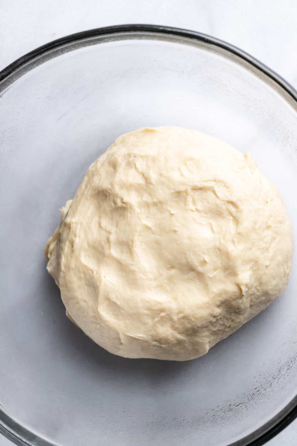 Dough in glass bowl before it rises.